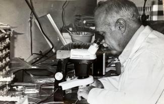 Technician looking through a microscope